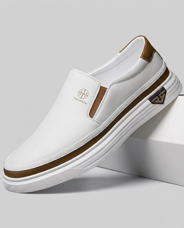 White slip-on shoe with brown accents on a gray background