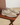 Pair of beige loafers with tassels on a wooden surface