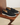 Black loafers with tassels on a wooden surface