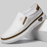 White slip-on shoe with brown accents on a gray background